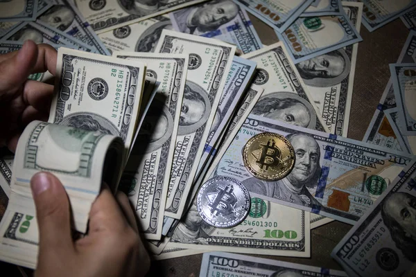 gamen.pro depositphotos 204036866 stock photo hand counting dollars bitcoin new